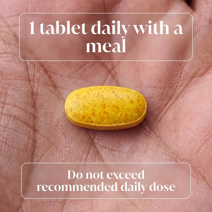 A yellow oval tablet resting on a person's palm, with text overlays reading '1 tablet daily with a meal' and 'Do not exceed recommended daily dose'.