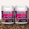 Two bottles of Nature's Best Milk Thistle supplement on a background with seeds.