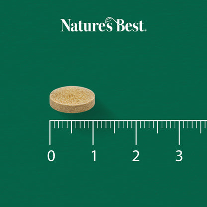 Nature's Best supplement tablet with a ruler for scale on a green background