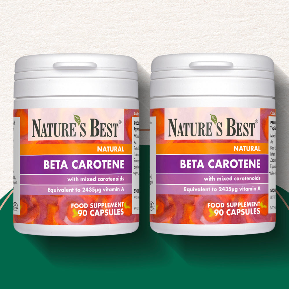 Two bottles of Nature's Best Beta Carotene capsules on a gradient background