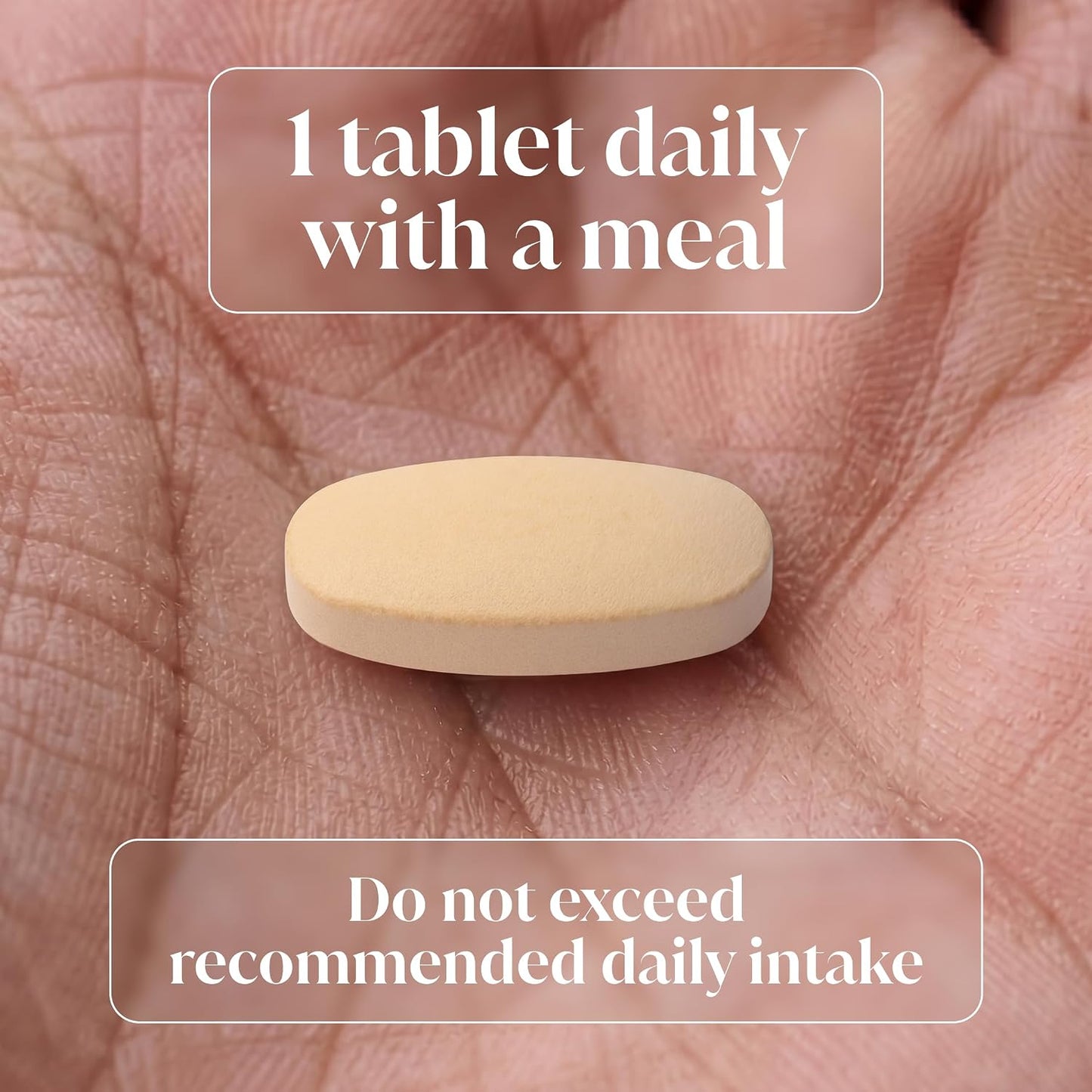 A single beige oval tablet resting on an open palm, with text overlays reading '1 tablet daily with a meal' and 'Do not exceed recommended daily intake'.