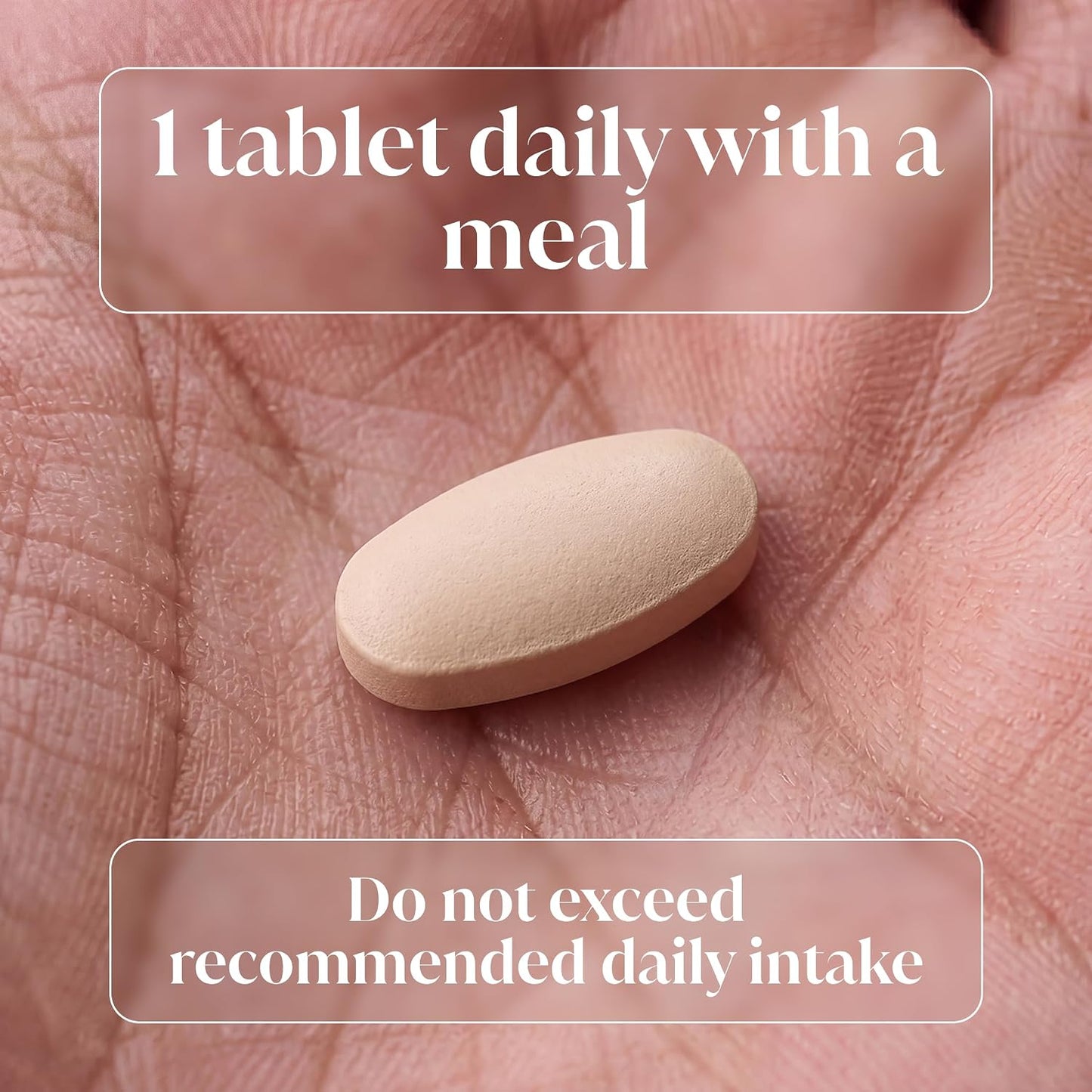 A single beige oval tablet resting on an open palm, with text overlays reading '1 tablet daily with a meal' and 'Do not exceed recommended daily intake'.