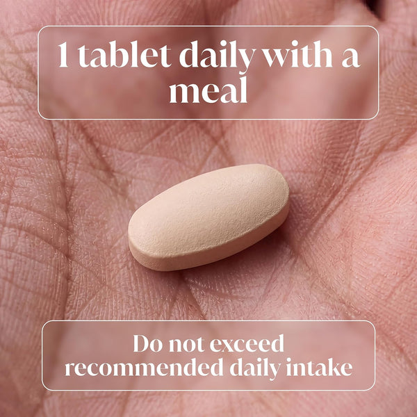 A single beige oval tablet resting on an open palm, with text overlays reading '1 tablet daily with a meal' and 'Do not exceed recommended daily intake'.