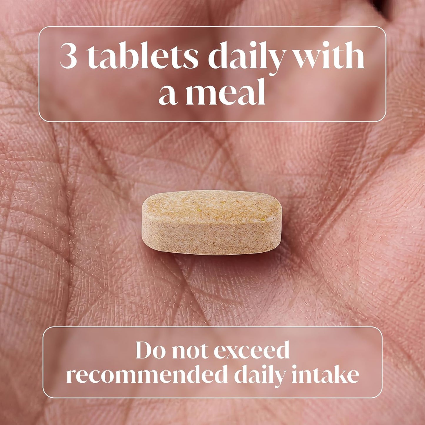 A single beige oval tablet resting on a person's palm, with overlaid text reading '3 tablets daily with a meal' and 'Do not exceed recommended daily intake'.