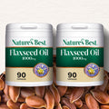 Two containers of Nature's Best Flaxseed Oil 1000mg with flaxseeds in the background.