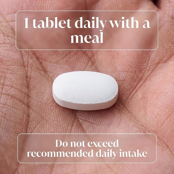 A white oval tablet resting on an open palm, with overlaid text reading '1 tablet daily with a meal' and 'Do not exceed recommended daily intake'.