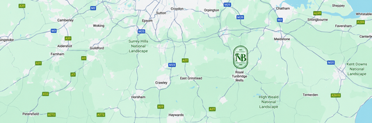 A green and white map showing a region with roads, place names, and a circular 'NB' logo near the center-right.
