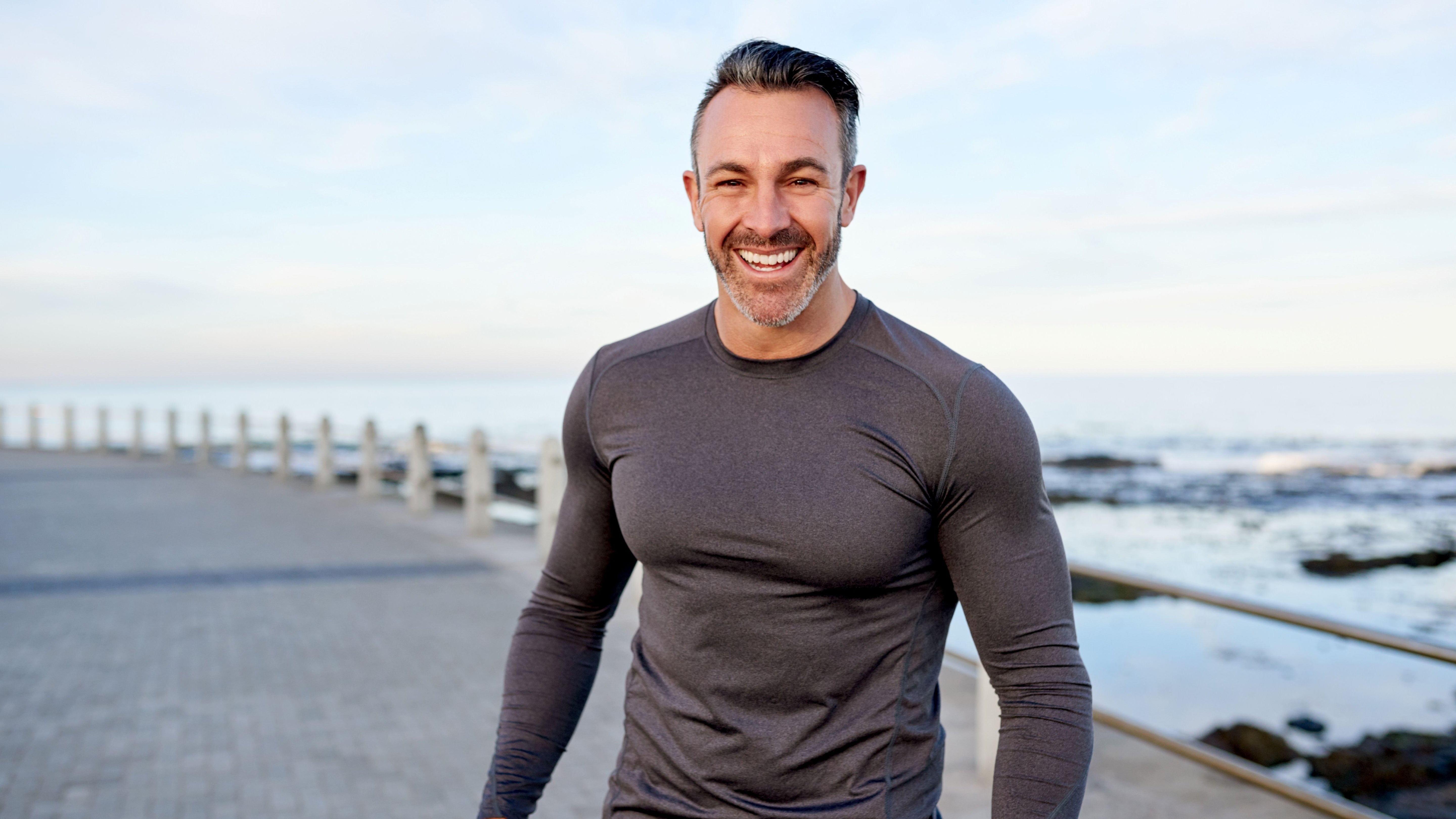 happy, athletic man smiling at the beach