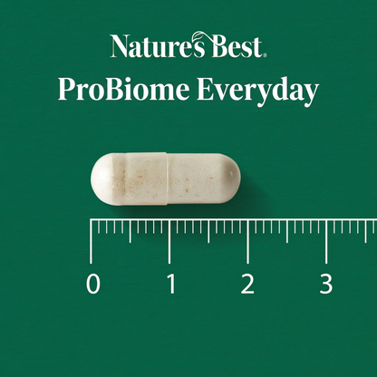 A single off-white capsule pill centered on a dark green background, with the text 'Natures Best ProBiome Everyday' above it and a ruler scale below showing millimeter measurements.