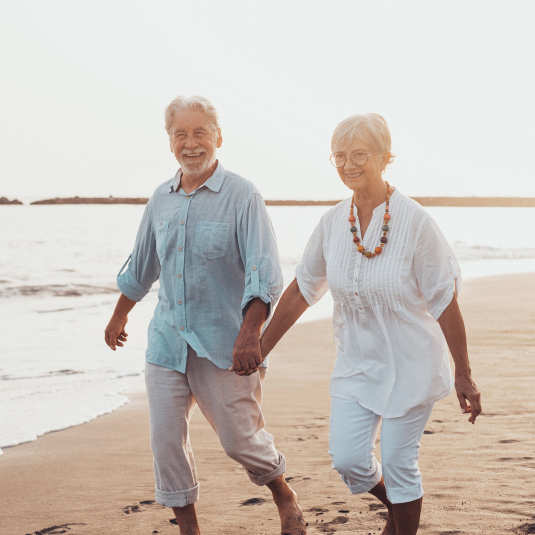 Senior couple walking on a beach together