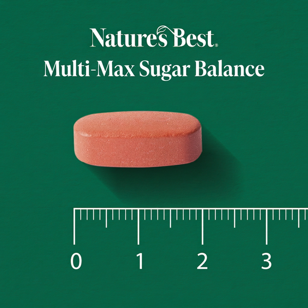 A single oval reddish-orange tablet centered on a dark green background, with the text 'Nature's Best Multi-Max Sugar Balance' above it and a ruler scale below showing 0 to 3 units for size reference.